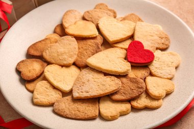 Plate with delicious heart shaped cookies, closeup. Valentines Day celebration