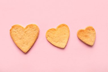 Sweet heart shaped cookies on pink background. Valentines Day celebration