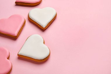 Different heart shaped cookies on pink background, closeup. Valentines Day celebration