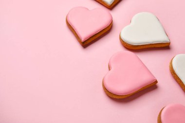 Different heart shaped cookies on pink background, closeup. Valentines Day celebration