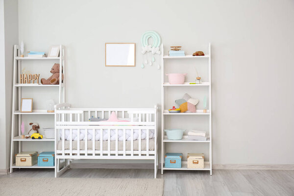 Stylish interior of children's room with baby bed