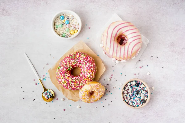 Parchments Different Delicious Donuts Bowls Sprinkles White Table — Stock Photo, Image