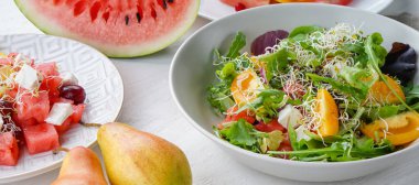 Plates with delicious salads on light table. Diet concept