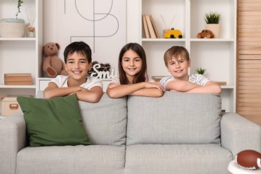 Little friends near sofa at home