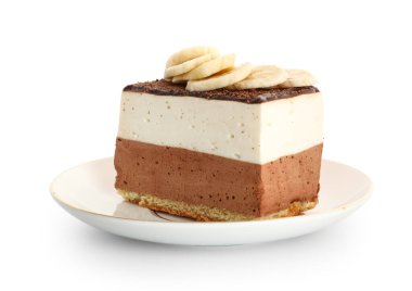 Plate with piece of birds milk cake and banana slices on white background