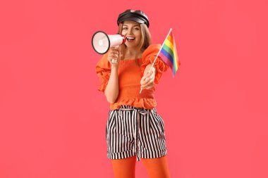 Beautiful young woman with LGBT flag shouting into megaphone on red background