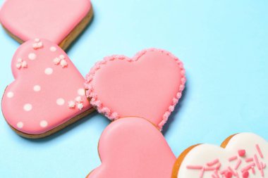 Composition with sweet heart shaped cookies on color background, closeup. Valentine's Day celebration