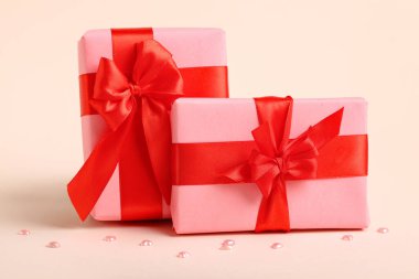 Beautiful gift boxes for Valentine's Day celebration on color background