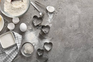 Composition with preparing tasty cookies and cutters on grunge background. Valentines Day celebration