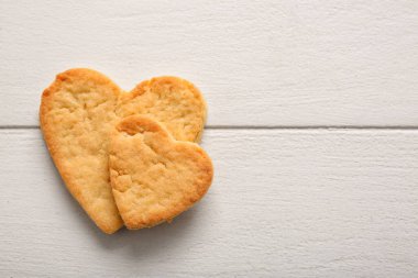 Sweet heart shaped cookies on light wooden background. Valentines Day celebration