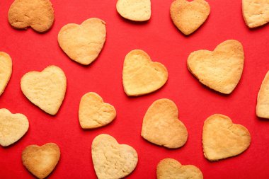Sweet heart shaped cookies on red background. Valentines Day celebration