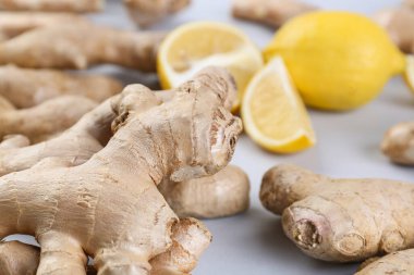 Fresh ginger roots on grey background, closeup