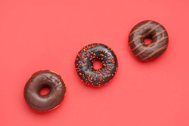 Delicious glazed donuts on red background