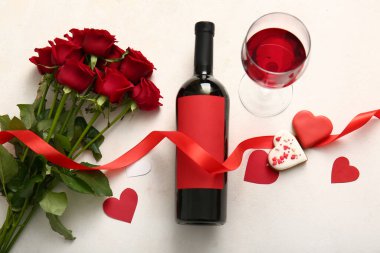 Bottle of wine, rose flowers, glass and hearts on white background. Valentine's Day celebration