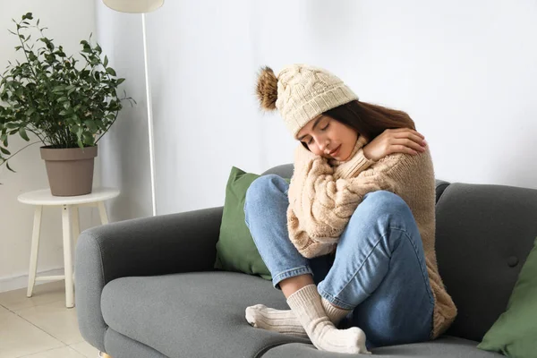 Frozen Young Woman Winter Clothes Sitting Sofa Home — Stock Photo, Image
