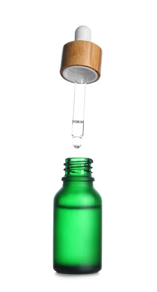 stock image Dripping of healthy serum into bottle on white background