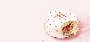 Plate with heart-shaped bento on pink background with space for text. Valentine's Day celebration