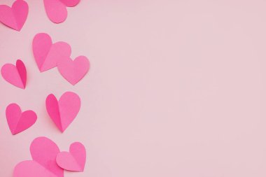 Composition with paper hearts on pink background. Valentines Day celebration