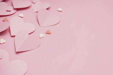 Composition with paper hearts on pink background. Valentines Day celebration