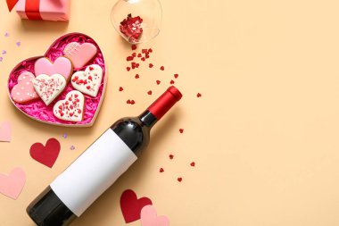 Composition with bottle of wine and cookies on color background. Valentines Day celebration