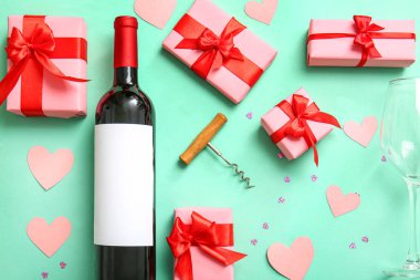 Composition with bottle of wine, corkscrew, gifts and decor on color background. Valentines Day celebration