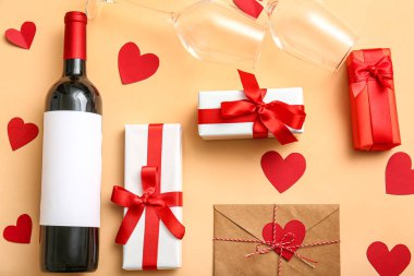 Composition with bottle of wine, glasses and gifts for Valentines Day on color background
