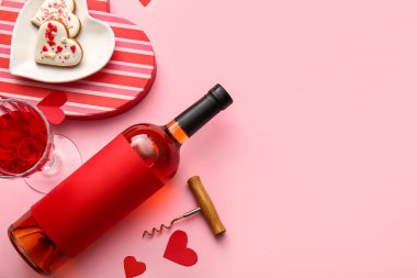 Composition with bottle of wine, glass, cookies and corkscrew on pink background. Valentines Day celebration