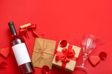 Composition with bottle of wine, glass, cookies and gifts for Valentines Day on red background