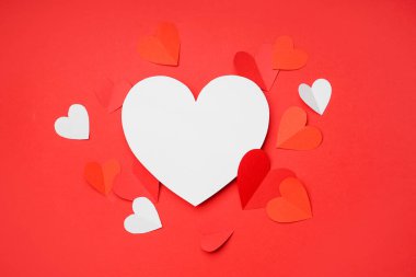 Beautiful paper hearts on red background. Valentines Day celebration