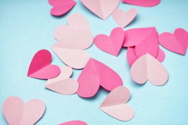 Beautiful paper hearts on blue background. Valentines Day celebration