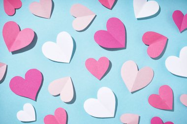 Beautiful paper hearts on blue background. Valentines Day celebration