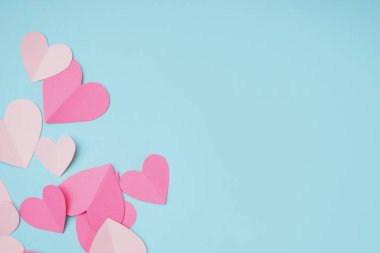Beautiful paper hearts on blue background. Valentines Day celebration
