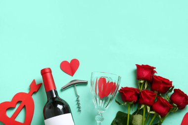 Bottle of wine, rose flowers and hearts on turquoise background. Valentine's Day celebration