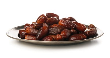 Plate with dried dates for Ramadan on white background