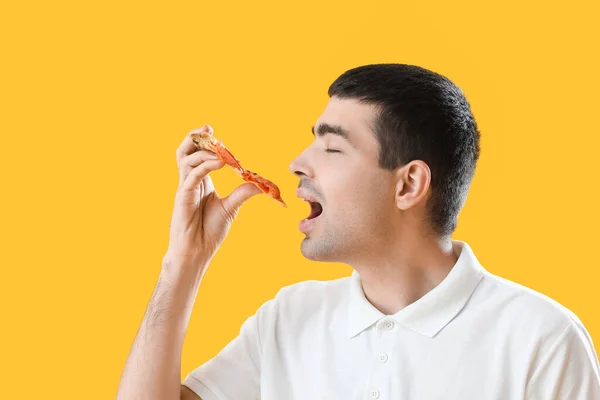 Young Man Eating Tasty Pizza Yellow Background Closeup — Stock Photo, Image