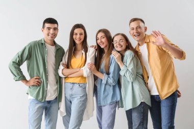 Group of happy friends on light background