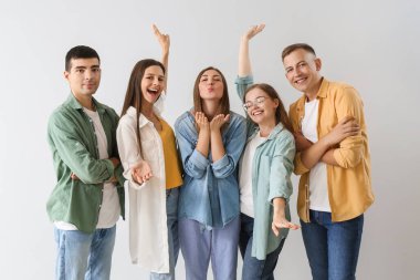 Group of happy friends on light background