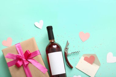 Composition with bottle of wine, corkscrew and gift for Valentines Day on color background