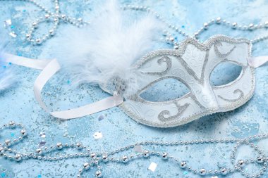 Carnival mask with beads and confetti on grunge background