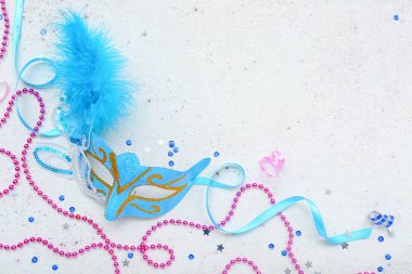 Carnival mask with beads and sequins on light background