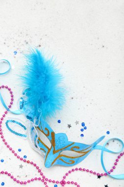 Carnival mask with beads and sequins on light background