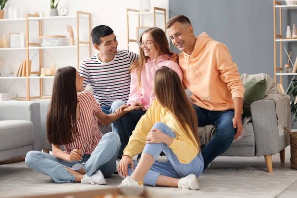 Group of friends talking in living room
