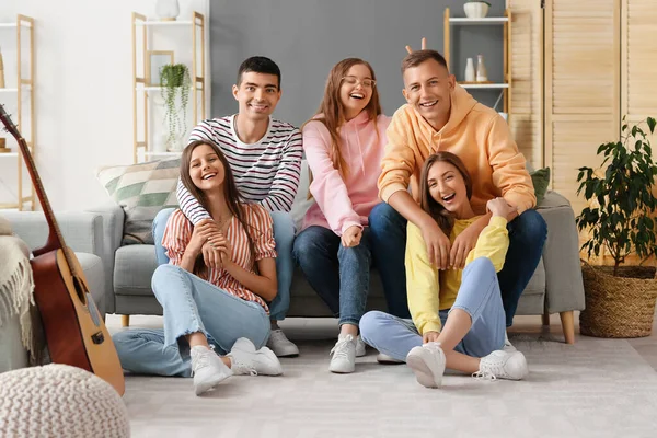 Group of friends resting in living room