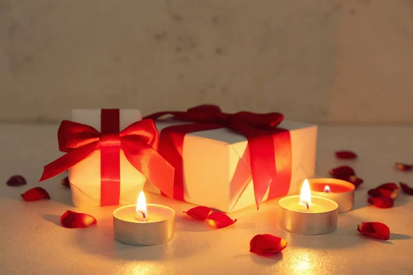Burning Candles Gift Boxes Rose Petals Light Background Valentine Day — Fotografia de Stock