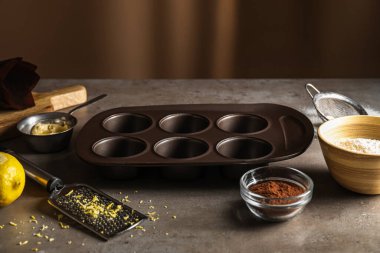 Tray and ingredients for preparing tasty muffins on table