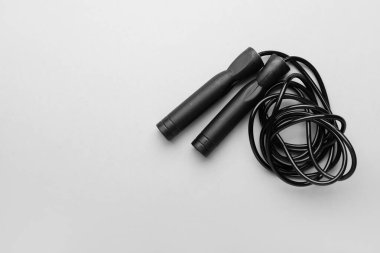 Black skipping rope on light background