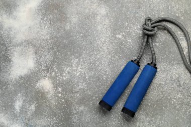 Blue skipping rope on dark background