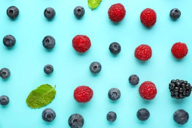 Composition with fresh berries on color background