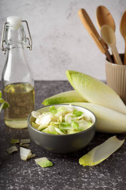 Bowl of cut fresh endive on table