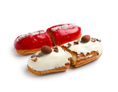 Halves of delicious eclairs isolated on white background